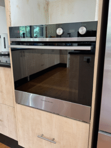 Licensed electrician installing an electric oven in an Epping NSW home