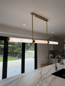 Electrician installing pendant lights in an Epping NSW home