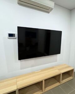 Electrician installing a wall mounted TV in an Epping NSW home